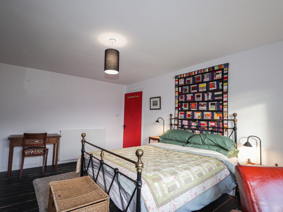 A bedroom with a bed and desk at Free Presbyterian Manse in Kinlochbervie