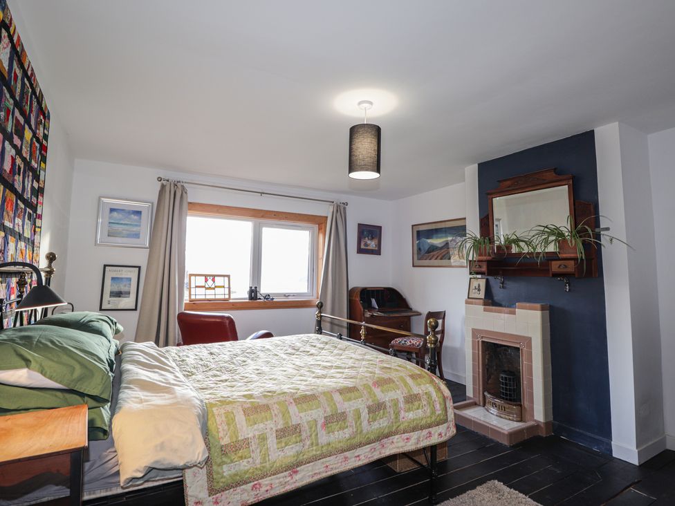 A bedroom with a bed and desk at Free Presbyterian Manse in Kinlochbervie