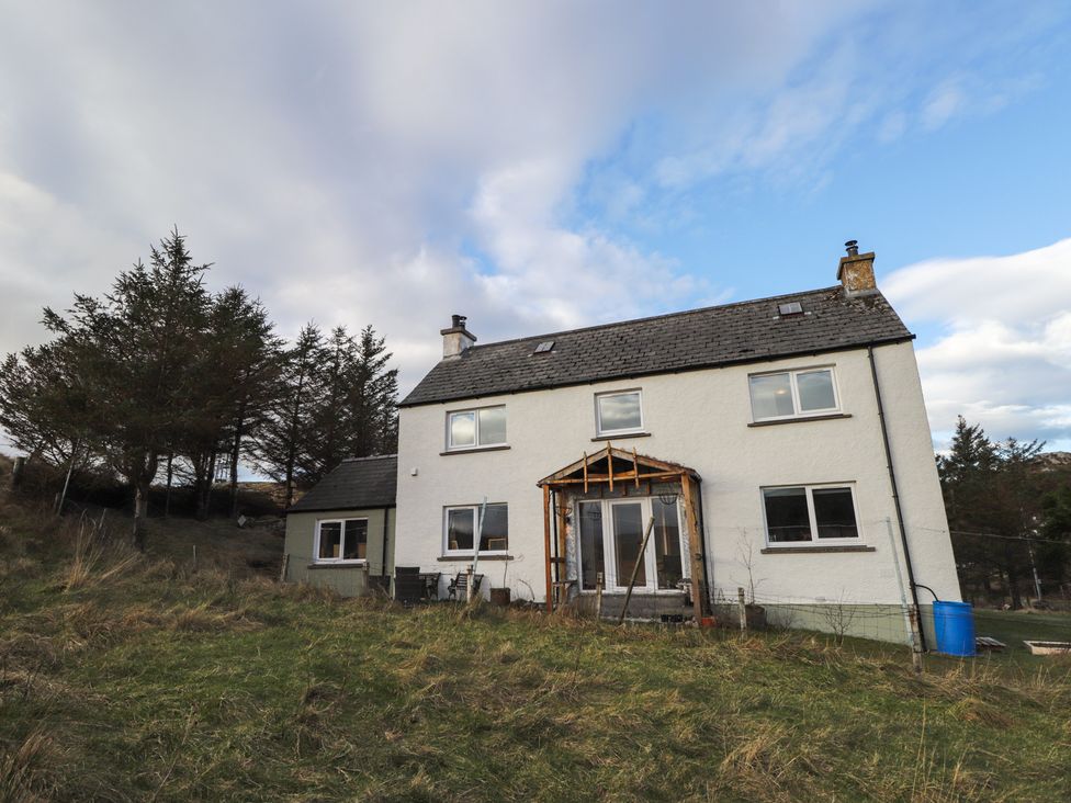 A house with trees and grass at Free Presbyterian Manse Kinlochbervie