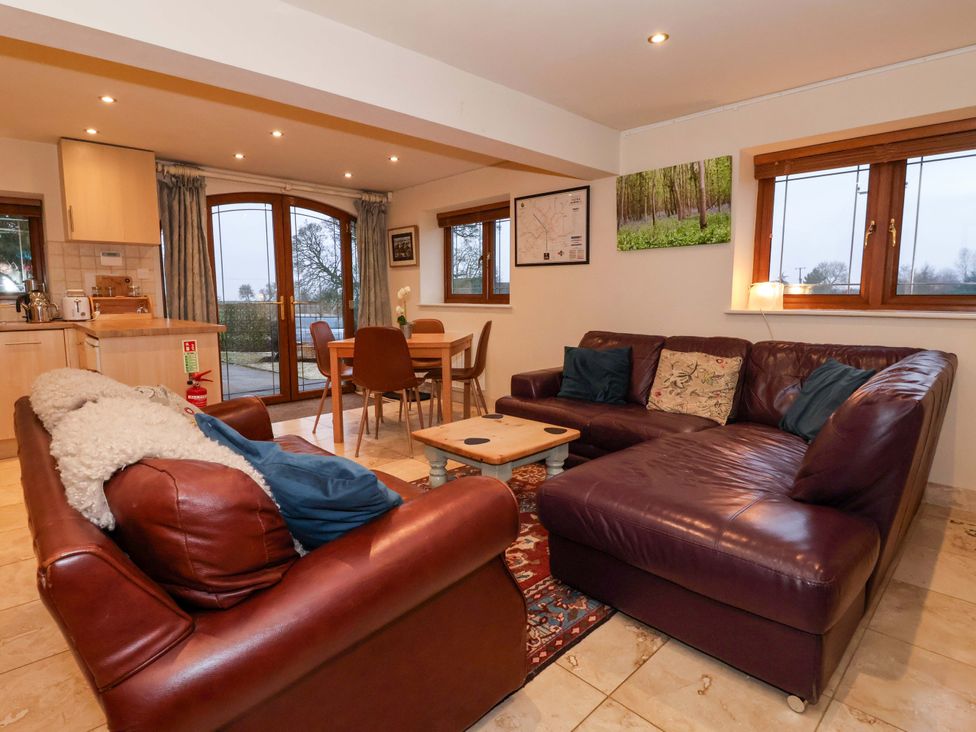 A living room with a sofa and dining area at Brush and Boot in York