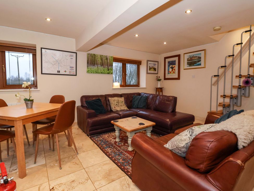 A living room with a dining table and sofa at Brush and Boot in York