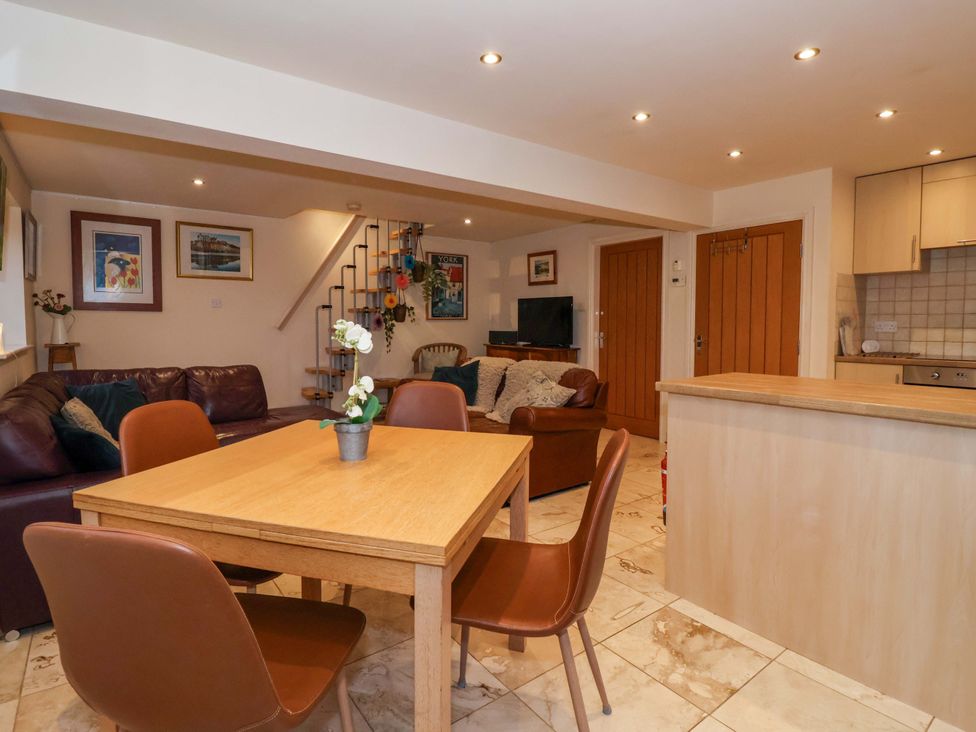A living room with a dining area and television at Brush and Boot in York