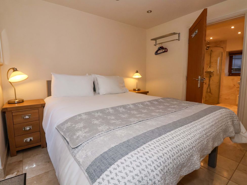 A bedroom with a bed and nightstand at Brush and Boot in York