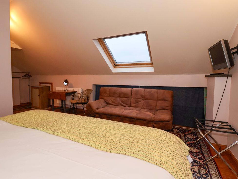 A bedroom with a bed and a sofa at Brush and Boot in York