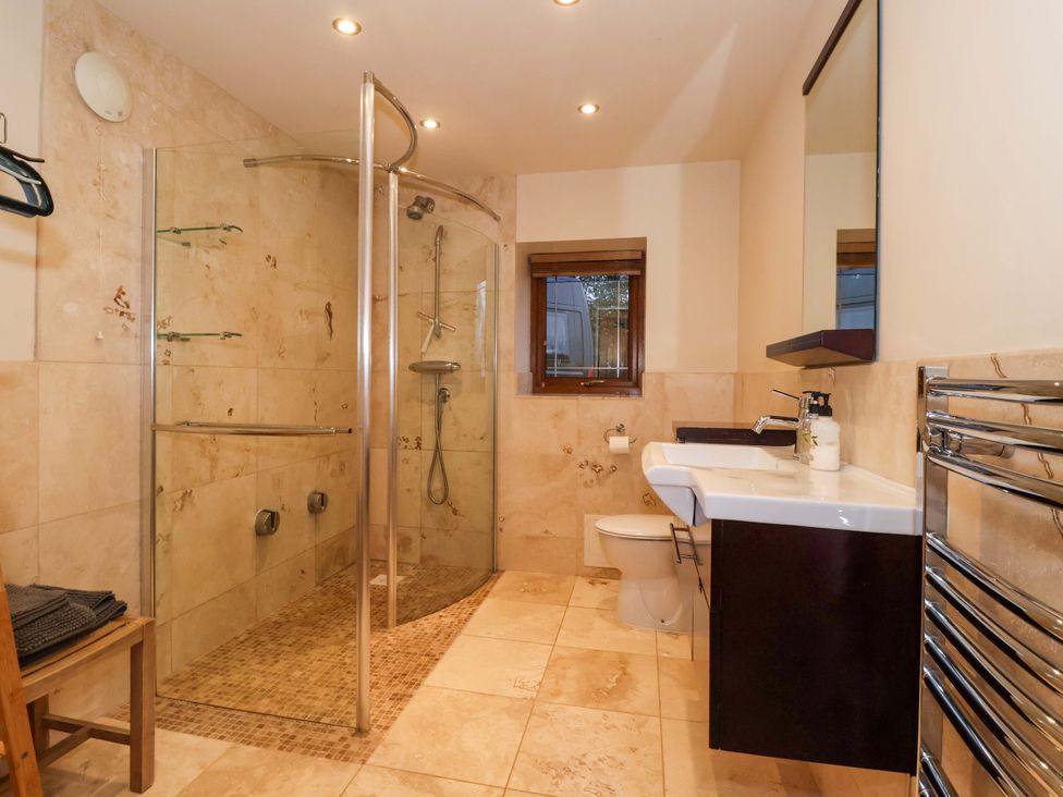 A bathroom featuring a shower, toilet, sink, and towel rack at Brush and Boot in York