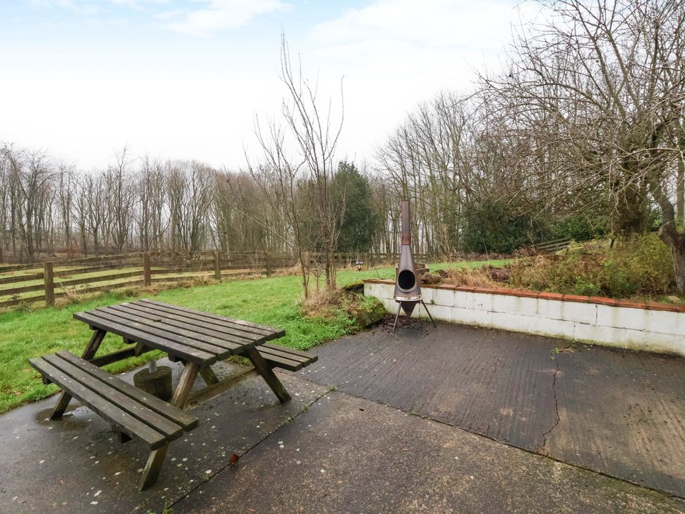 An outdoor area with a table and benches at Brush and Boot in York
