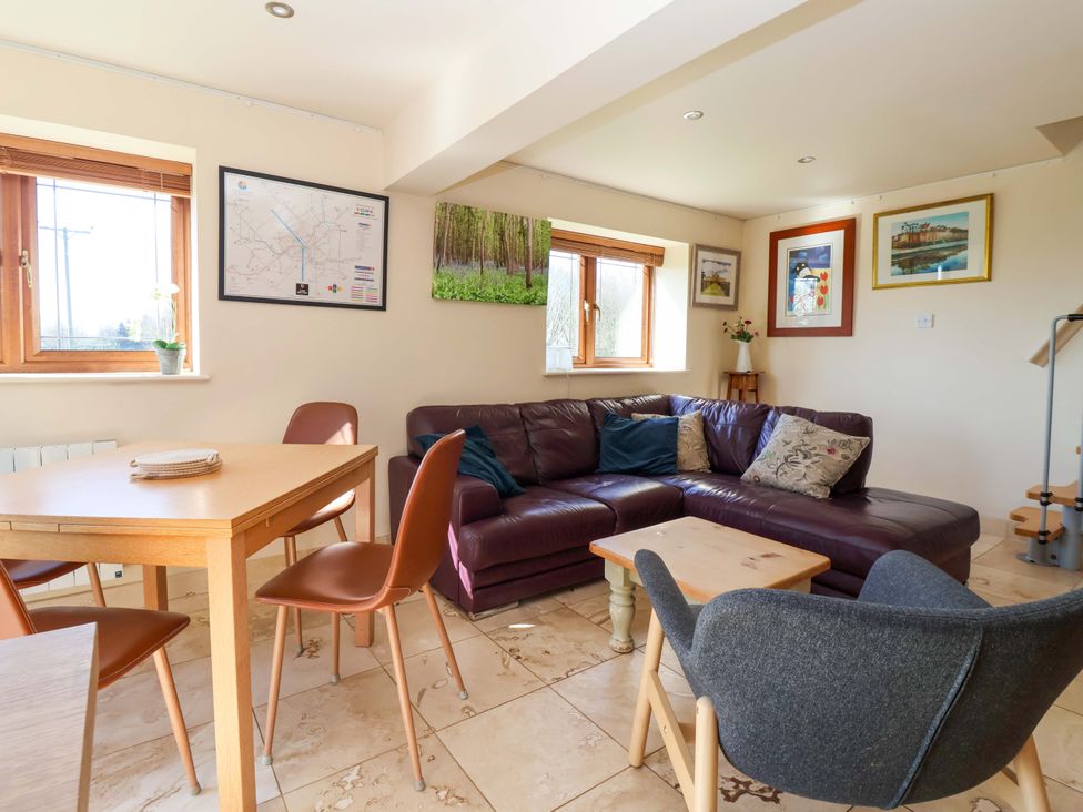 A living room with a sofa and table at Brush and Boot in Stittenham near York