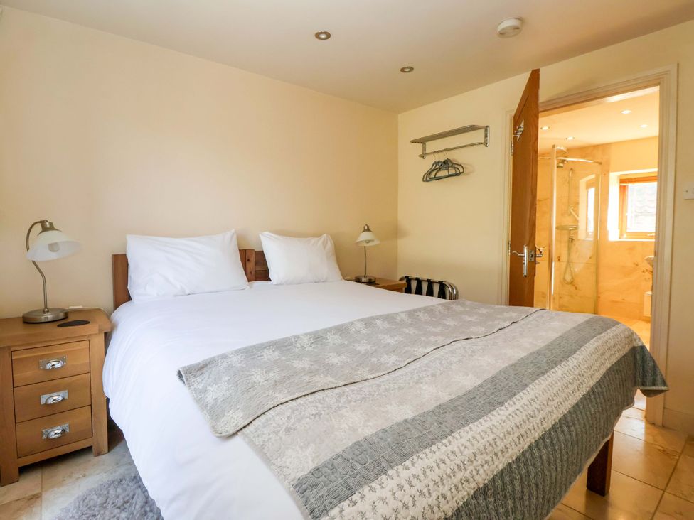 A bedroom with a bed and an attached bathroom at Brush and Boot in Stittenham near York