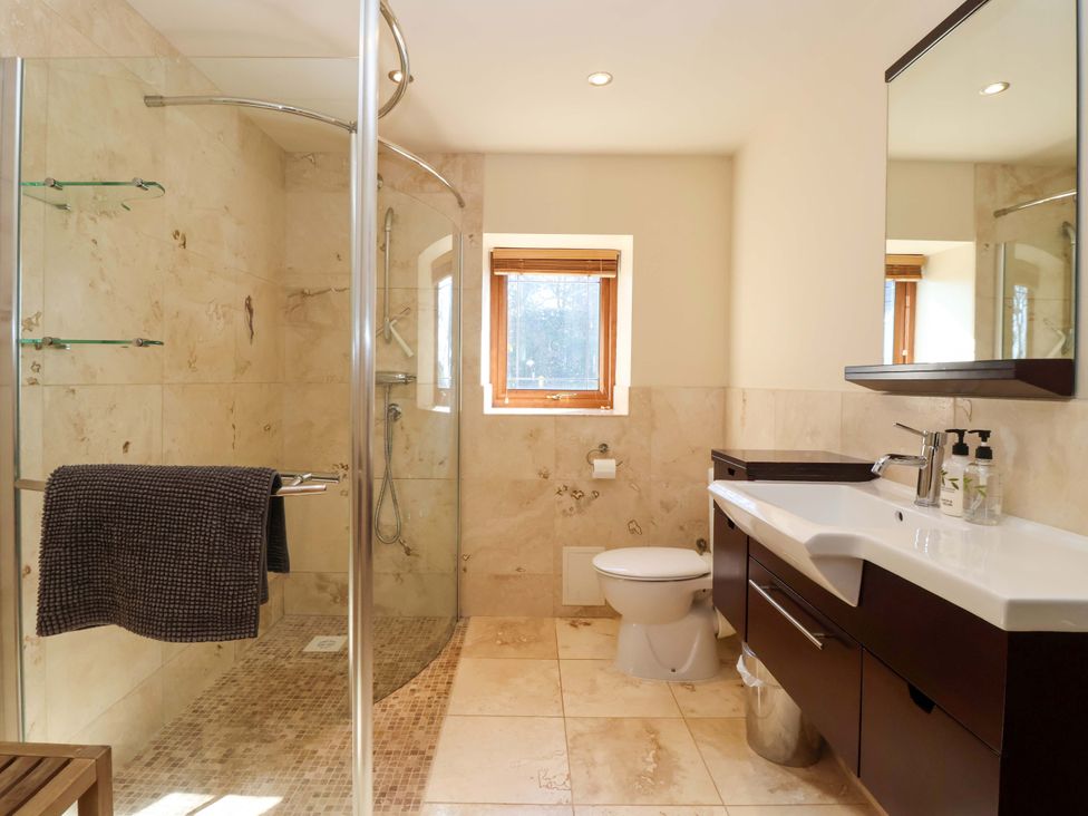 A bathroom with a shower, toilet, and sink at Brush and Boot in Stittenham near York