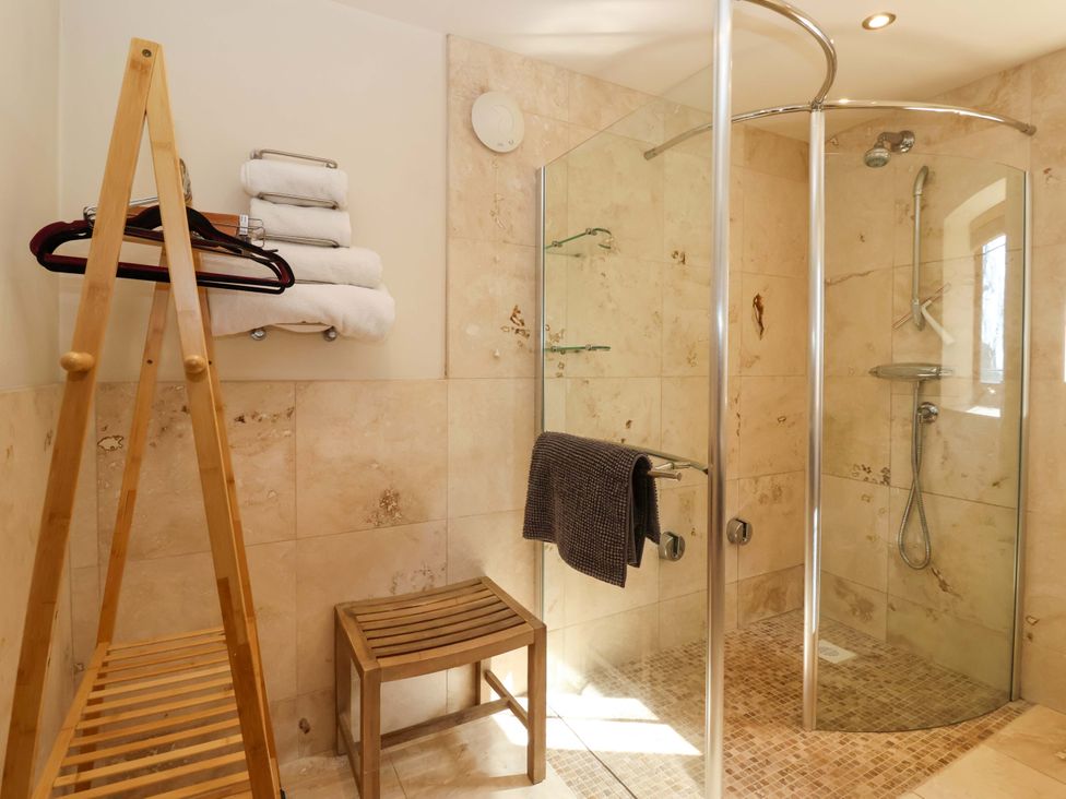 A bathroom with a shower and towels at Brush and Boot in Stittenham near York