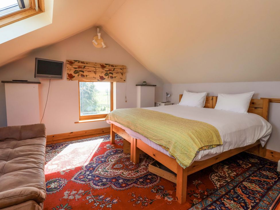 A bedroom with a bed and sofa at Brush and Boot in Stittenham near York