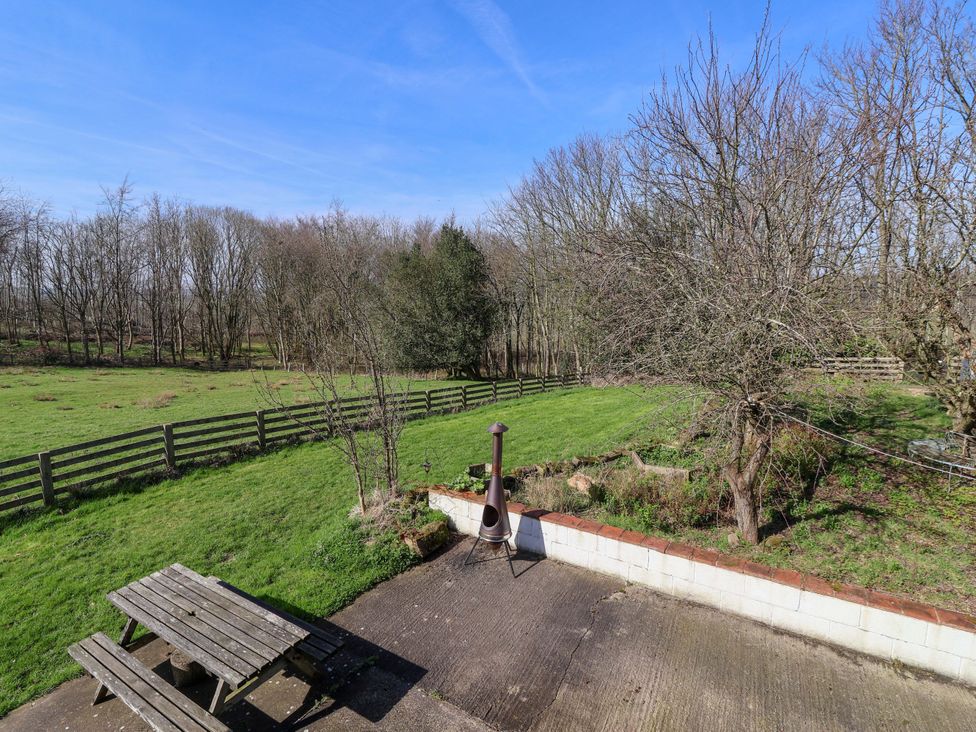 A garden area with a table and benches at Brush and Boot in Stittenham near York