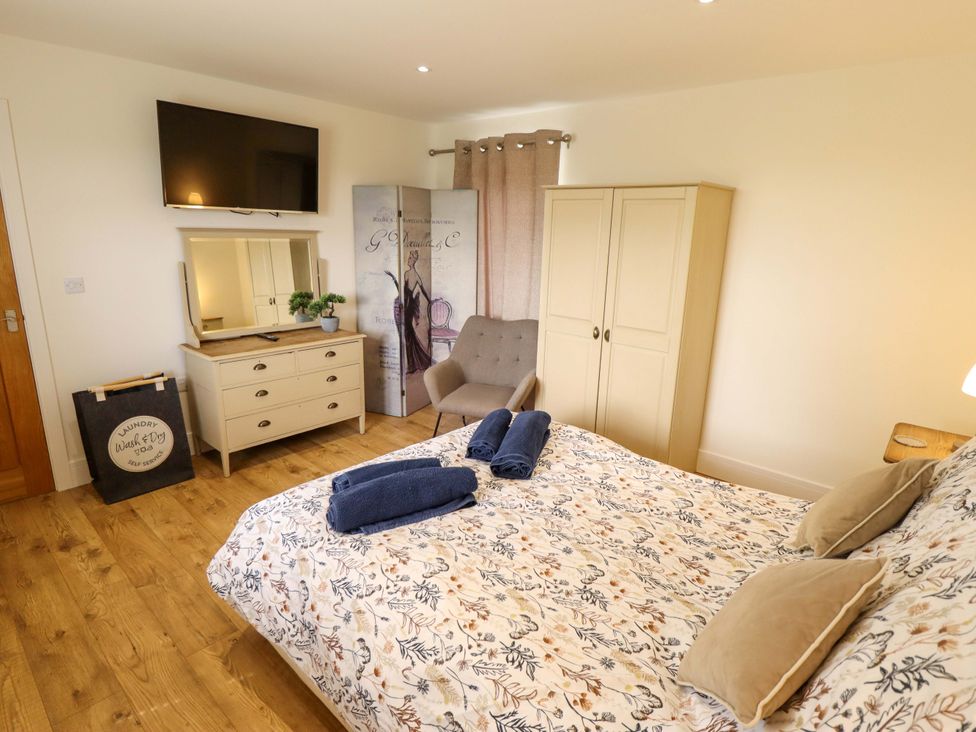 A bedroom with a bed and television at The New Build in South Reston near Louth