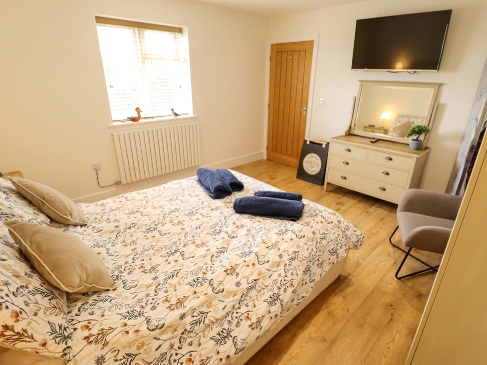 A bedroom with a bed and dresser at The New Build in South Reston near Louth