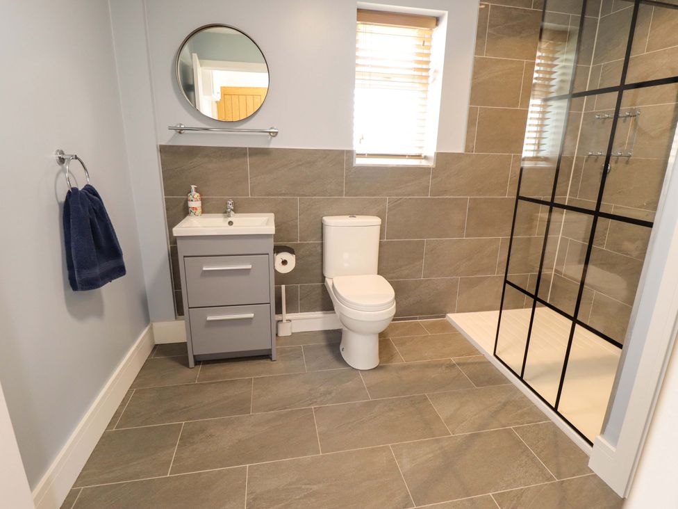 A bathroom with a shower and sink at The New Build in South Reston near Louth