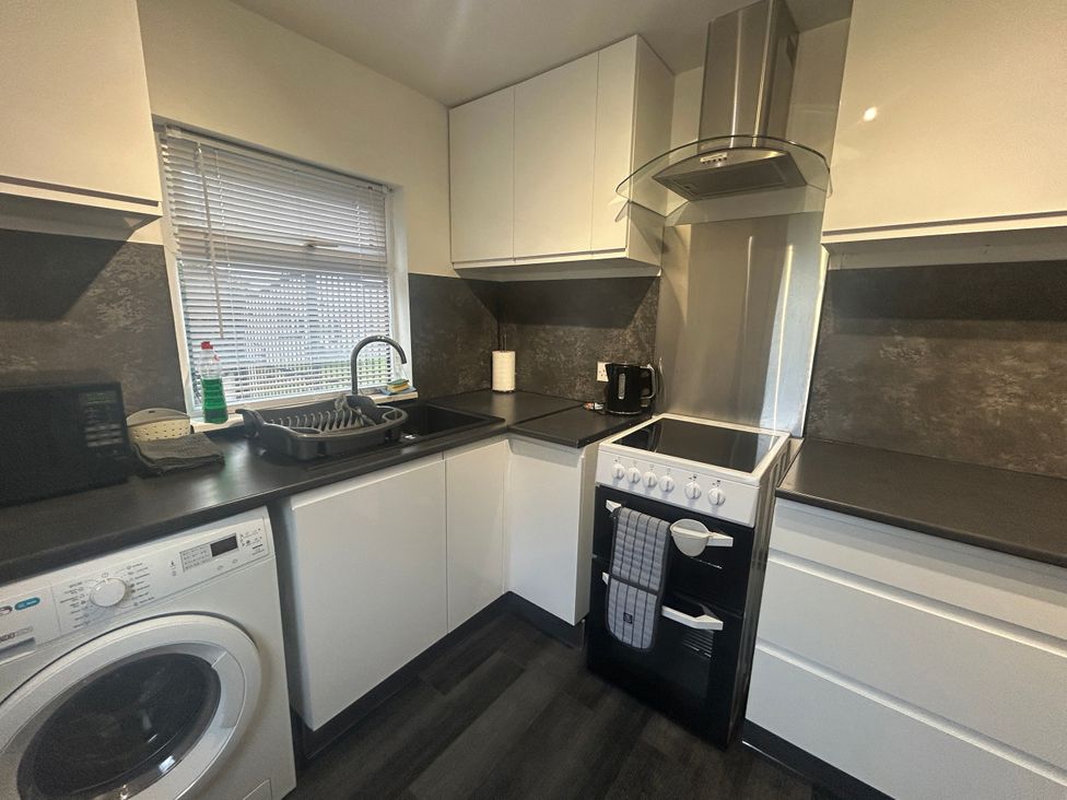 A kitchen with a sink and oven at Solway Firth View Powfoot near Annan