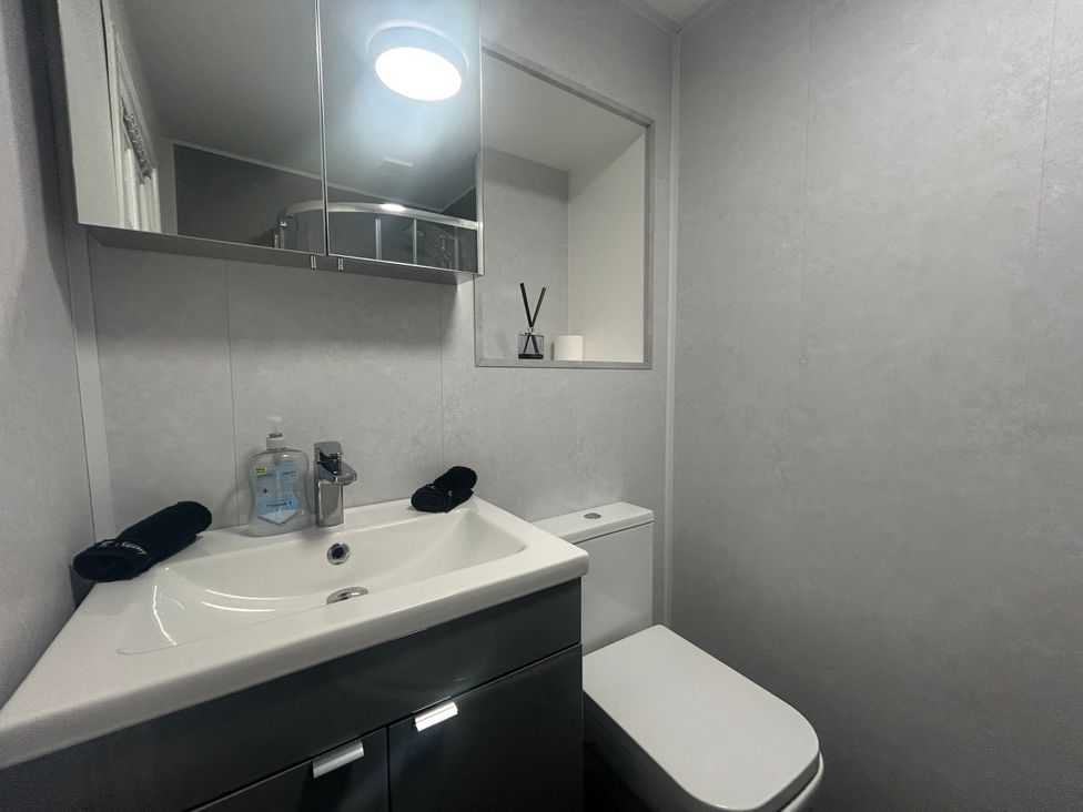 A bathroom with a sink and toilet at Solway Firth View Powfoot near Annan