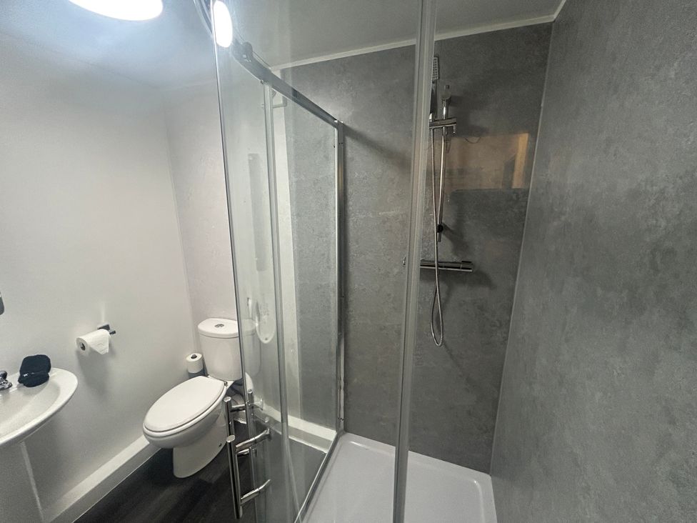 A bathroom with shower toilet and sink at Solway Firth View in Powfoot near Annan