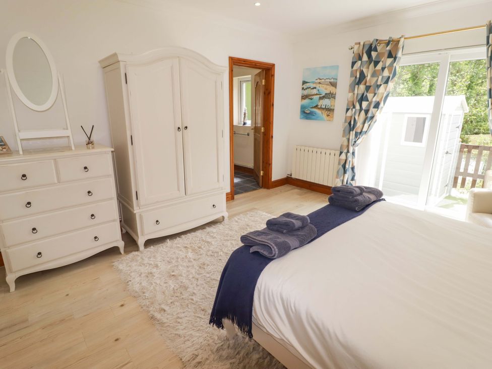 A bedroom with a wardrobe and chest of drawers at Charlecote House Saundersfoot