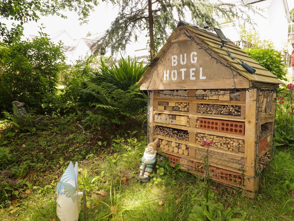 A bug hotel and garden gnome in a garden at Charlecote House Saundersfoot