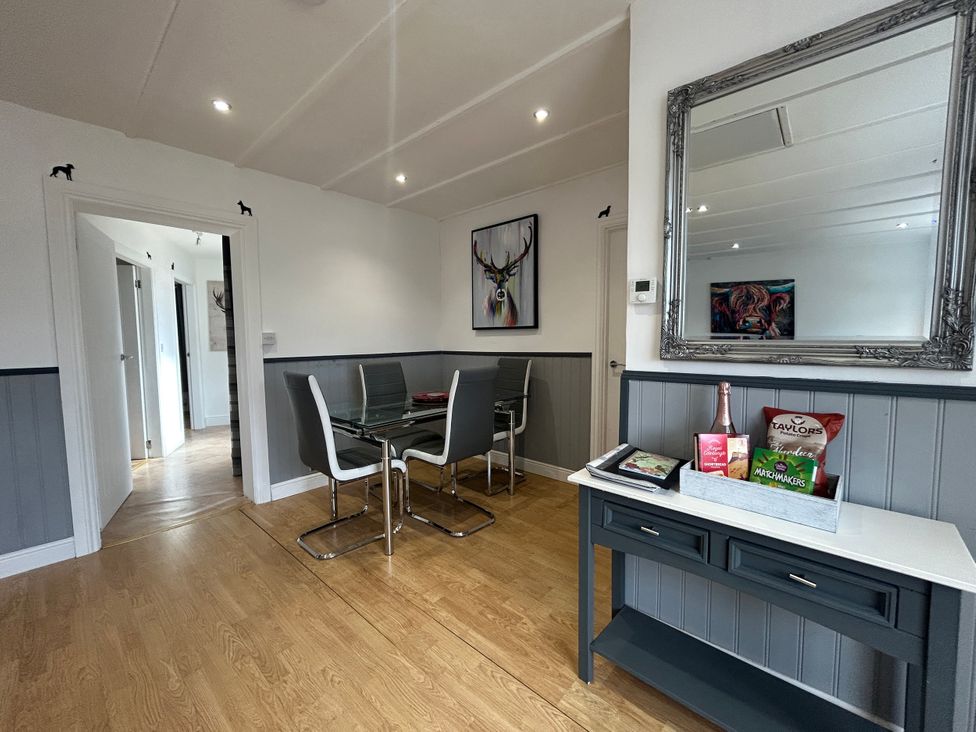 A dining room with a table and chairs at Solway Cottage in Powfoot near Annan