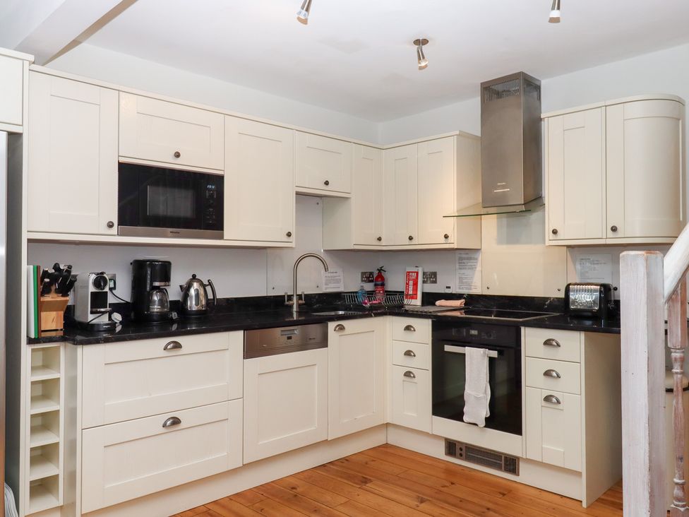 A kitchen with appliances and cabinetry at 13 Above Town Dartmouth