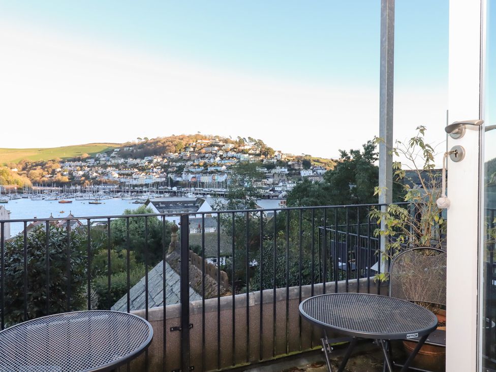 A balcony with seating overlooking a harbor at 13 Above Town Dartmouth