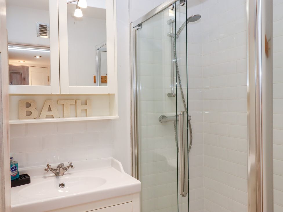 A bathroom with a shower and sink at 13 Above Town in Dartmouth