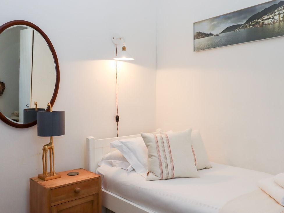 A bedroom with a single bed and a lamp at 13 Above Town in Dartmouth