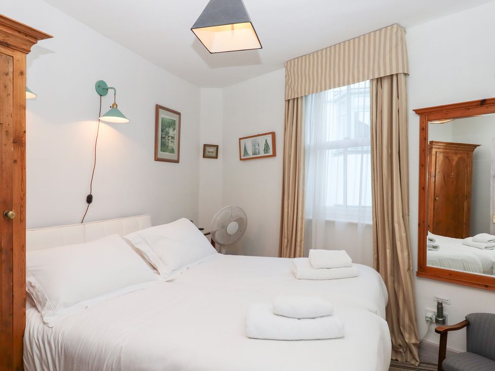 A bedroom with two beds and decorative items at 13 Above Town in Dartmouth