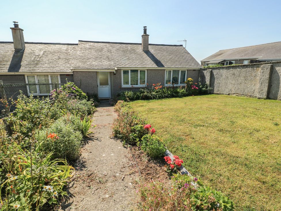 A house with a garden and pathway at 7 Bro Branwen Aberffraw near Rhosneigr