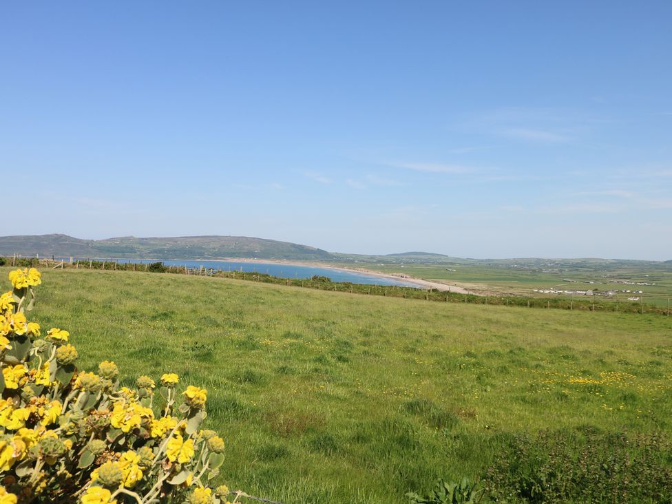 A view of the sea and grassy landscape at Sunstone (Garreg Haul) Cilan near Abersoch