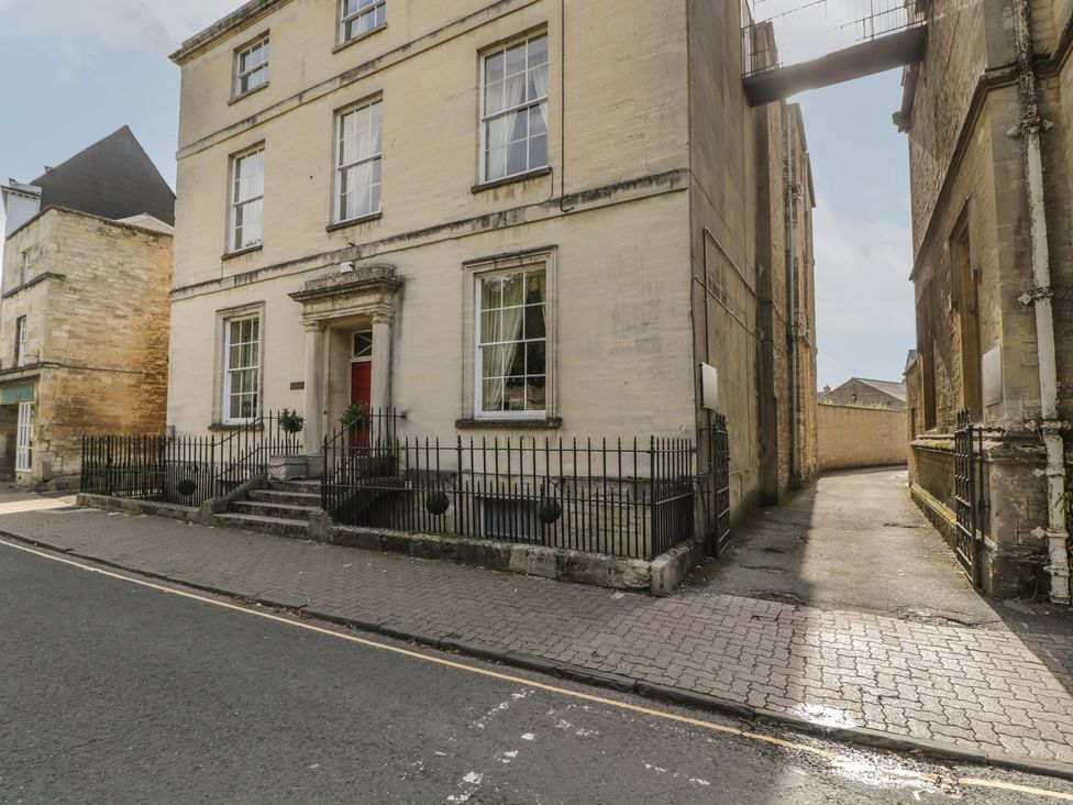 A building exterior with a red door and windows at Dollar Ward House Basement Cirencester