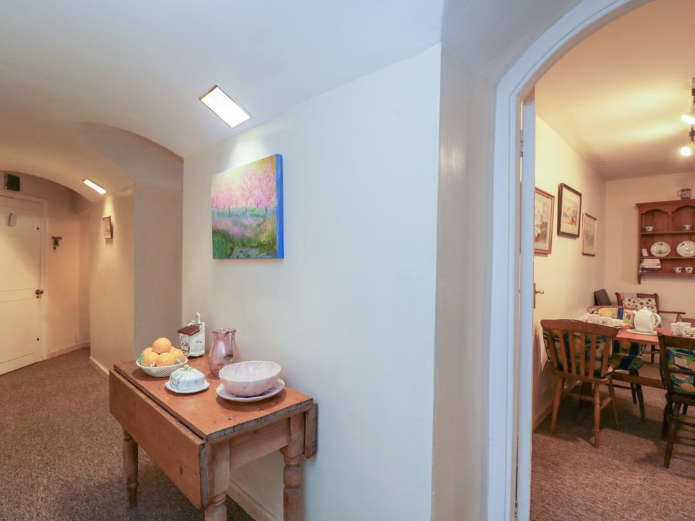 A hallway with a table and chair at Dollar Ward House Basement Cirencester