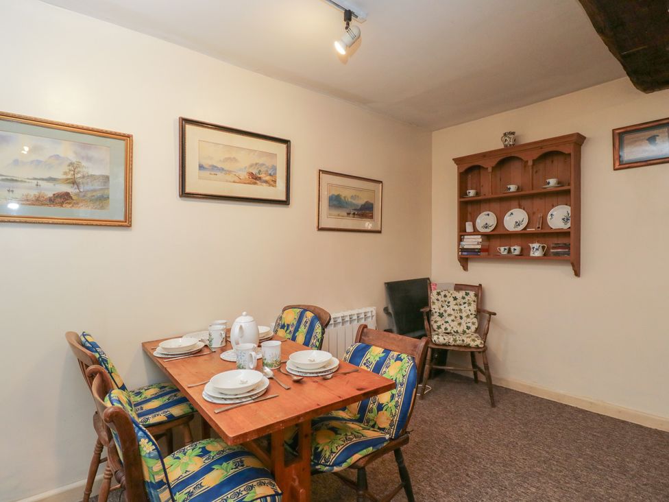 A dining room with a table and chairs at Dollar Ward House Basement Cirencester