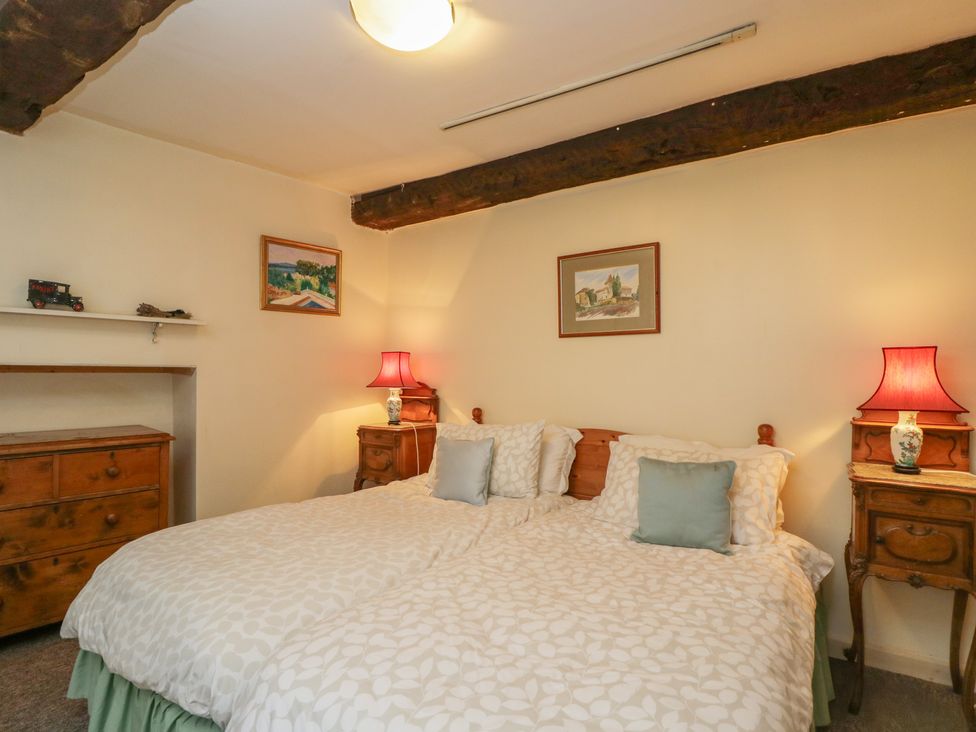 A bedroom with a double bed and lamps at Dollar Ward House Basement Cirencester