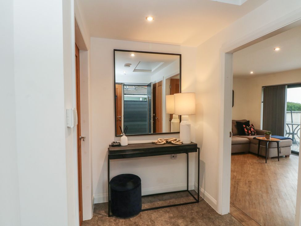 An entrance hall with a console table and mirror at View@Langho, Langho, Lancashire