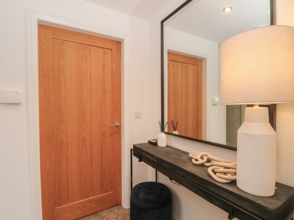 A hallway with a door and a console table at View@Langho, Langho, Lancashire