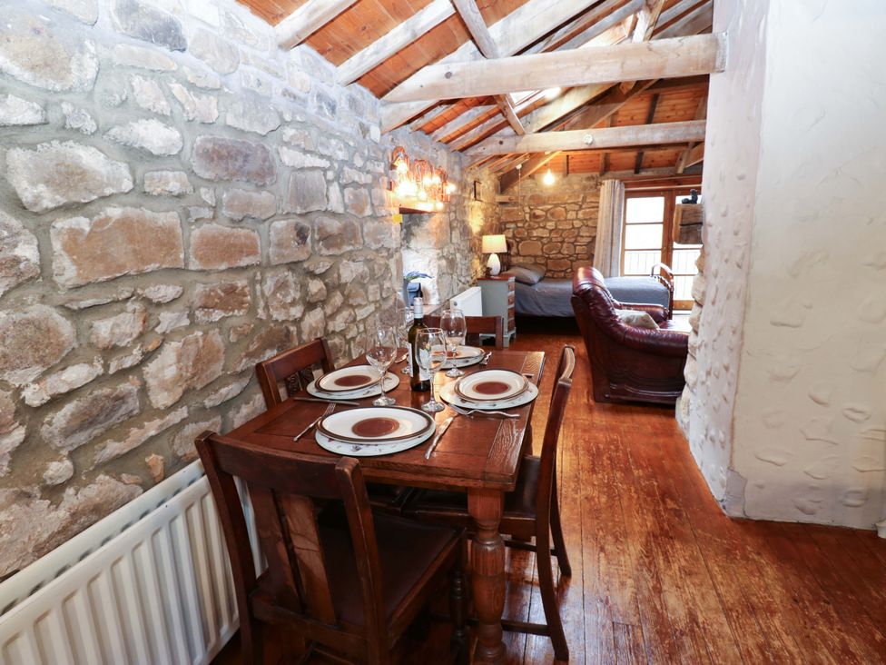 A dining area with a table and chairs at The Granary in Rothbury