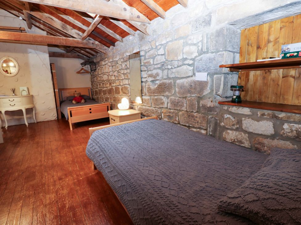 A bedroom with two beds and furniture at The Granary in Rothbury