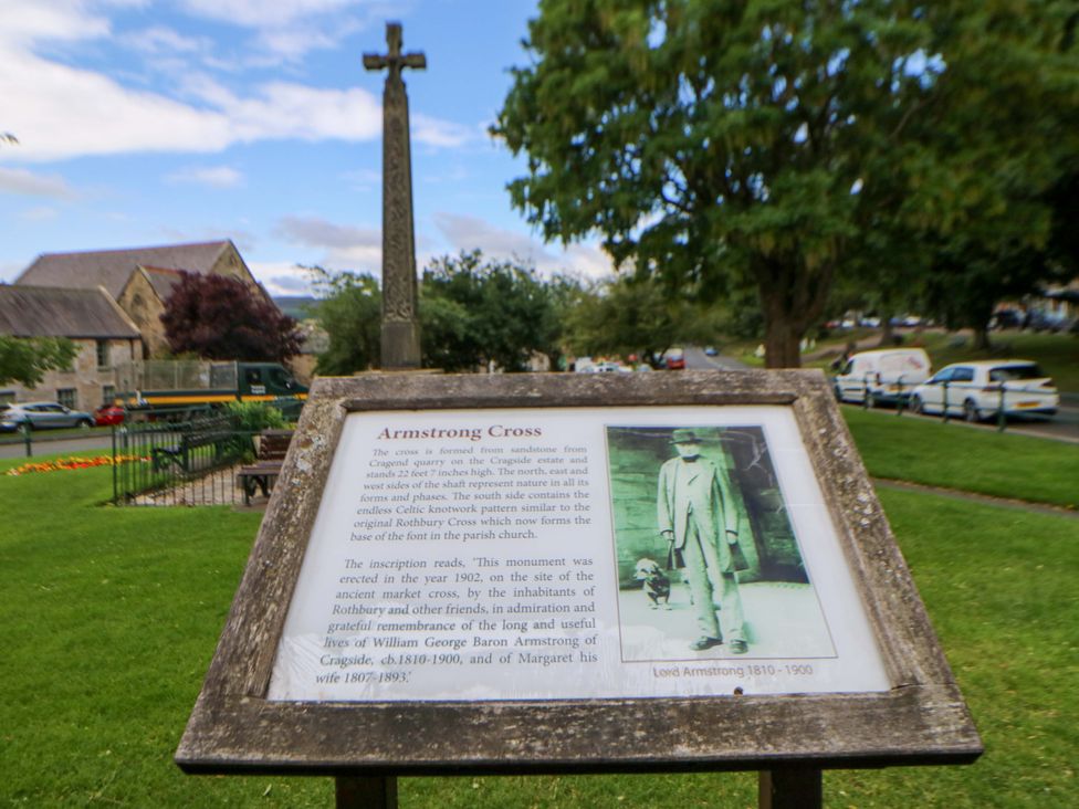 A park with Armstrong Cross and information sign at The Granary Rothbury