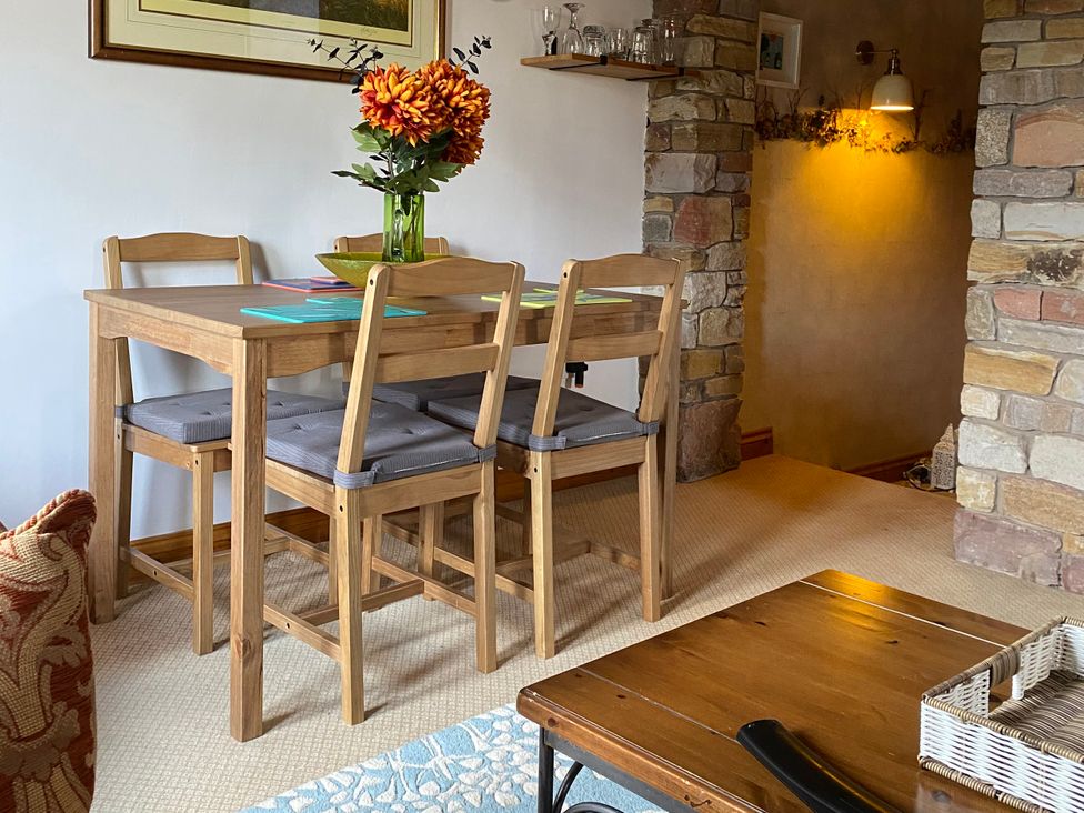 A dining room with a table and chairs at Swaledale Watch Garden Annexe in Caldbeck