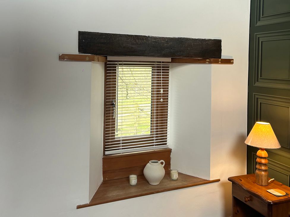 A living room with a window and shelf at Swaledale Watch Garden Annexe in Caldbeck