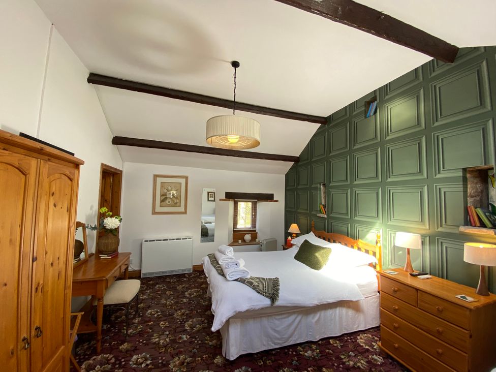 A bedroom with a bed and furniture at Swaledale Watch Garden Annexe in Caldbeck