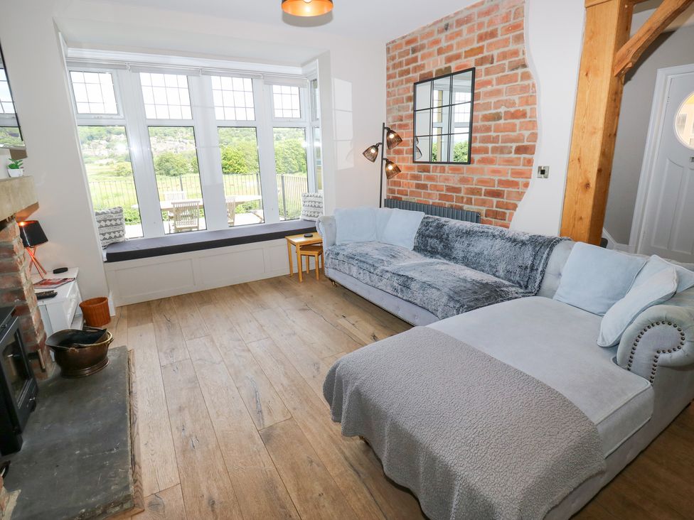 A living room with a sofa and fireplace at Farnhill View in Cross Hills