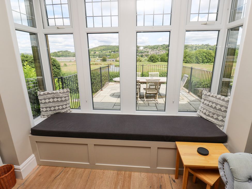 A conservatory with a bench by the window at Farnhill View in Cross Hills
