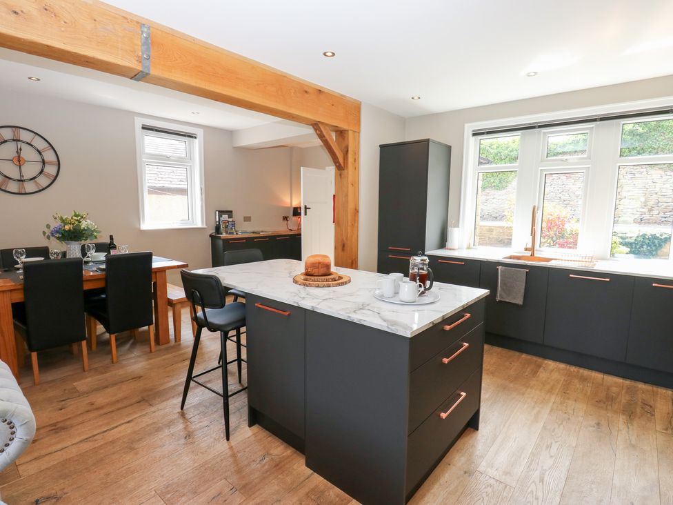 A kitchen with a dining table and chairs at Farnhill View in Cross Hills