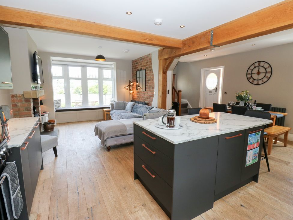 A living room with kitchen island and sofa at Farnhill View in Cross Hills