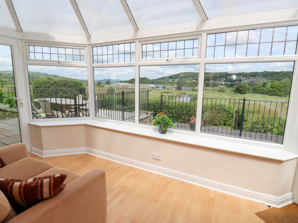 A conservatory with windows overlooking the countryside at Farnhill View in Cross Hills