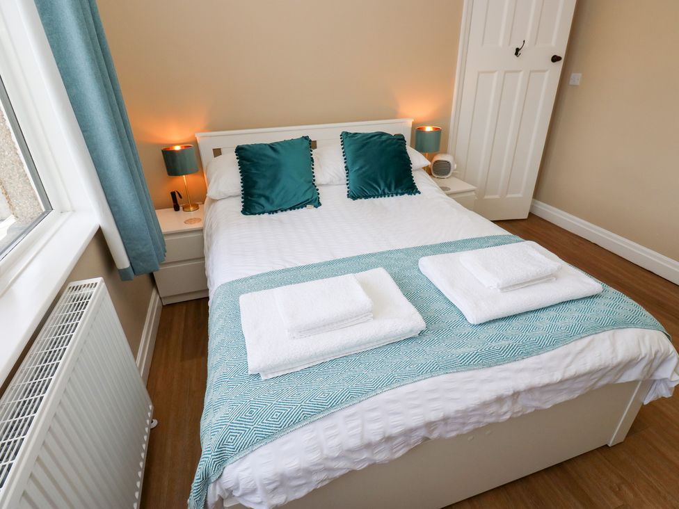 A bedroom with a bed and pillows at Farnhill View Cross Hills